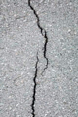 Crack on the grey concrete surface. Brake, broken concept