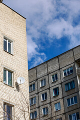 Tall apartment buildings on blue sky nof with clouds