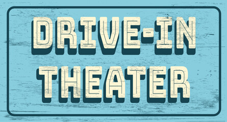 Vintage drive-in theater sign on wood grain