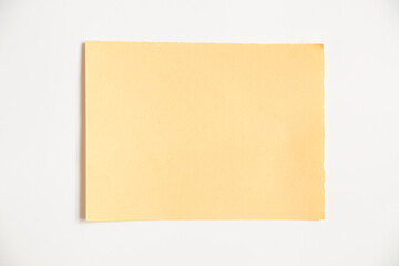 Yellow paper card isolated on white background close up