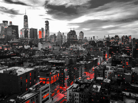 Fototapeta New York City black and white nighttime cityscape with glowing red lights in the skyline buildings of downtown Manhattan