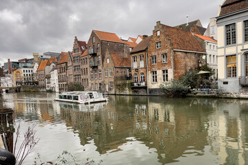 Fototapeta na wymiar City tour boat sailing on the canal in Ghent, Belgium