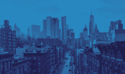 New York City overhead view of Madison Street in Chinatown and the downtown skyline buildings with blue color effect