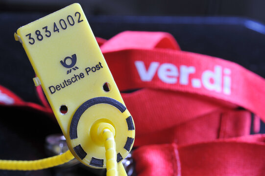 Hamburg, Germany - March 12, 2023: pull-trough seal of Deutsche Post and a lanyard with the logo of  trade union ver.di