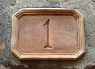 street number of the house with the digit 1 on the marble tile