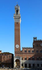 Fototapeta premium Siena Italy Tower called TORRE DEL MANGIA and the Cappella a marble tabernacle at the foot of the tower