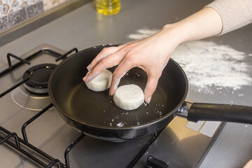The girl is making cheese pancake in the kitchen 