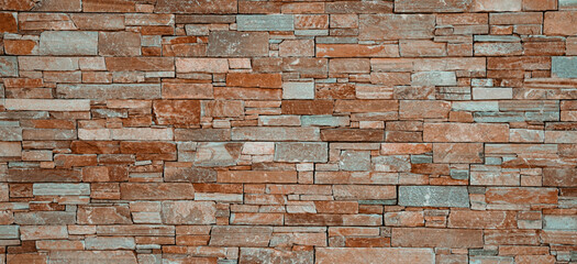 Modern stone brick wall surface background. Brown masonry wall of stones with irregular pattern texture background