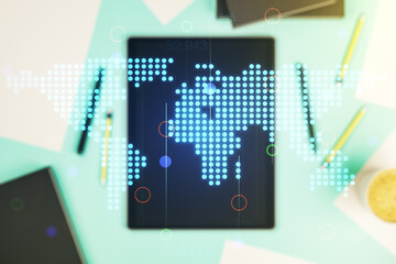 Double exposure of abstract digital world map and modern digital tablet on background, big data and blockchain concept