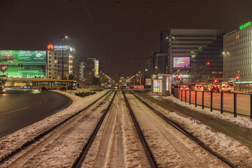 Fototapeta na wymiar street at night in Warsaw with warm color and snow
