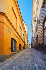 Narrow small streets and courtyards of old part of Swedish Stockholm: sunny February tourist day in capital of Scandinavia, Gamla Stan island.