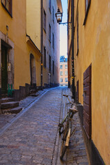 Narrow small streets and courtyards of old part of Swedish Stockholm: sunny February tourist day in capital of Scandinavia, Gamla Stan island.