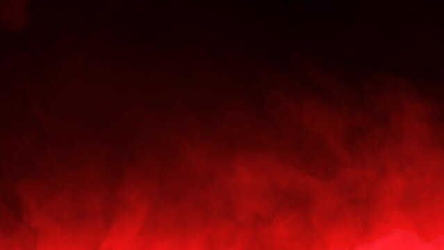 Red smoke on a dark background, slow motion.