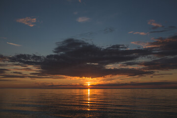 Yellow sunset and mirroring calm sea water
