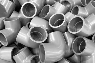 Grey pvc plumbing pipes corners background closeup