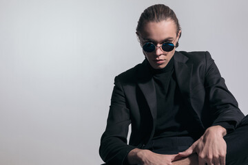 Obraz premium businessman looking over his sunglasses at camera