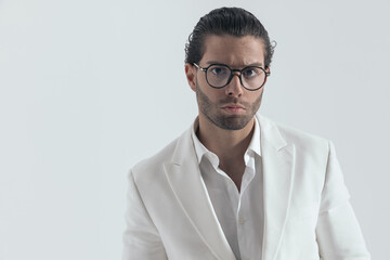 cool fashion man with glasses wearing white jacket suit and open collar shirt