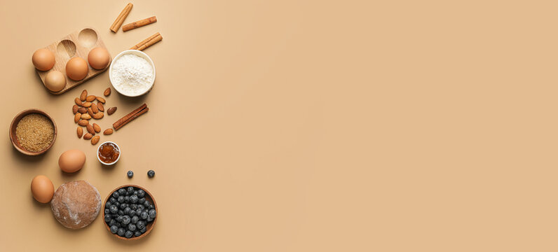 Ingredients for preparing bakery on brown background with space for text