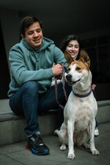 Happy family with their dog in the city. Dog with his family. the dog looks into the distance.