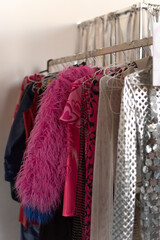Fashion clothes hanging on a rail. Stylish wardrobe. 