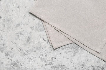 Folded napkin on grunge background, closeup