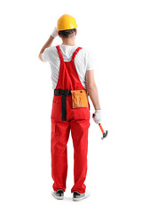 Young carpenter with hammer on white background, back view