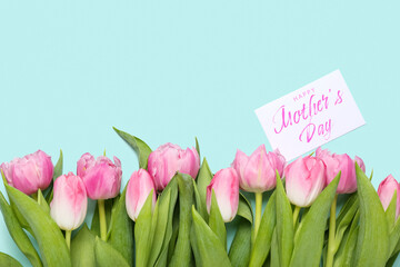 Greeting card with text HAPPY MOTHER'S DAY and beautiful tulip flowers on turquoise background