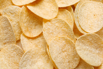 Delicious potato chips as background
