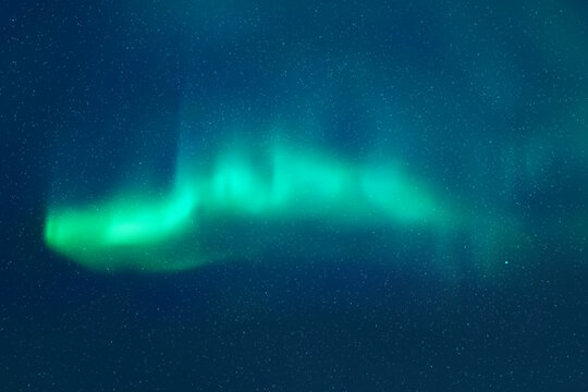 Blue night starry sky and Northern lights. Green aurora borealis