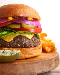 Burger-with-all-toppings-classic-american-brioche-bun-tomato-pickles-onions-cheese-french-fries