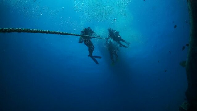 Red Sea, Egypt, Mart 3, 2019: Divers in clear underwater slow motion. Diving is an exciting and adventurous activity that involves exploring underwater world.