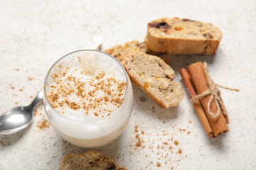Delicious biscotti cookies, cinnamon and cup of coffee on white grunge background