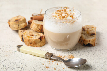 Delicious biscotti cookies, cinnamon and cup of coffee on white grunge background