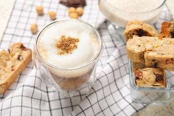 Delicious biscotti cookies and cup of coffee on napkin