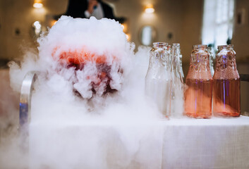 A beautiful chemical effect, liquid nitrogen with white vapor in a large jar, a cocktail from a...