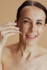 Portrait of happy modern woman isolated on beige background