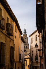 Fototapeta na wymiar View of Cathedral spire down an alley in Segovia Spain