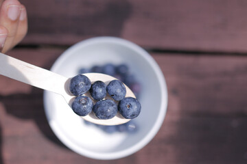 top view of fresh blue berry on a spoon 