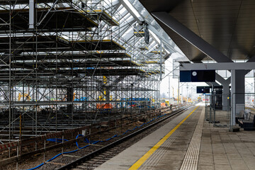 Extensive scaffolding providing platforms for work on a new railway station building - obrazy, fototapety, plakaty