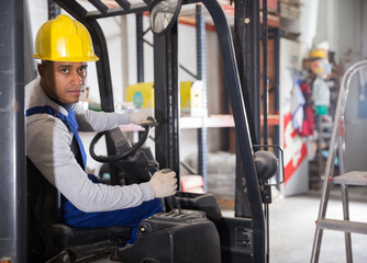Forklift driver at the warehouse of a hardware store