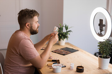 Bearded man professional beauty make up artist vlogger or blogger recording makeup tutorial to share on website or social media.