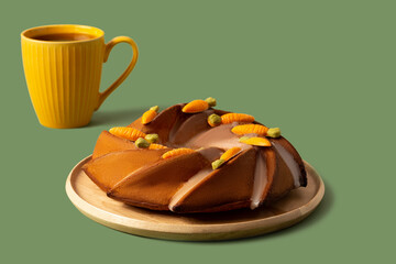 Easter cake with carrot decoration on a green background