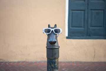 Ornate horse hitching post in the French Quarter of New Orleans, with sunglasses on for Mardi Gras...