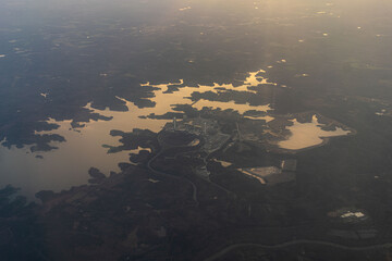 Nuclear power plant by a lake from the air at sunset