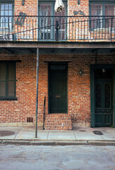 A classic house in the New Orleans French Quarter with a beer on its front step - Portrait
