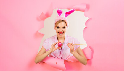 Obraz na płótnie Canvas Happy Easter day. Smiling woman in bunny ears painting eggs for Easter holiday. Rabbir gitl with painted Easter egg. Egg hunt. Bunny rabbit woman. Sale. Discount. Easter eggs decorating ideas.