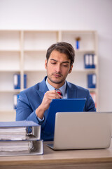 Young male employee working in the office