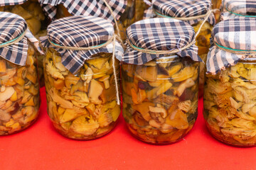 Glass jars with different types of canned mushrooms