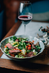 warm salad with herbs and vegetables with red wine