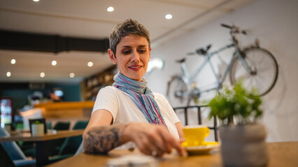 Fototapeta premium One woman senior caucasian female sit at cafe have a cup of coffee